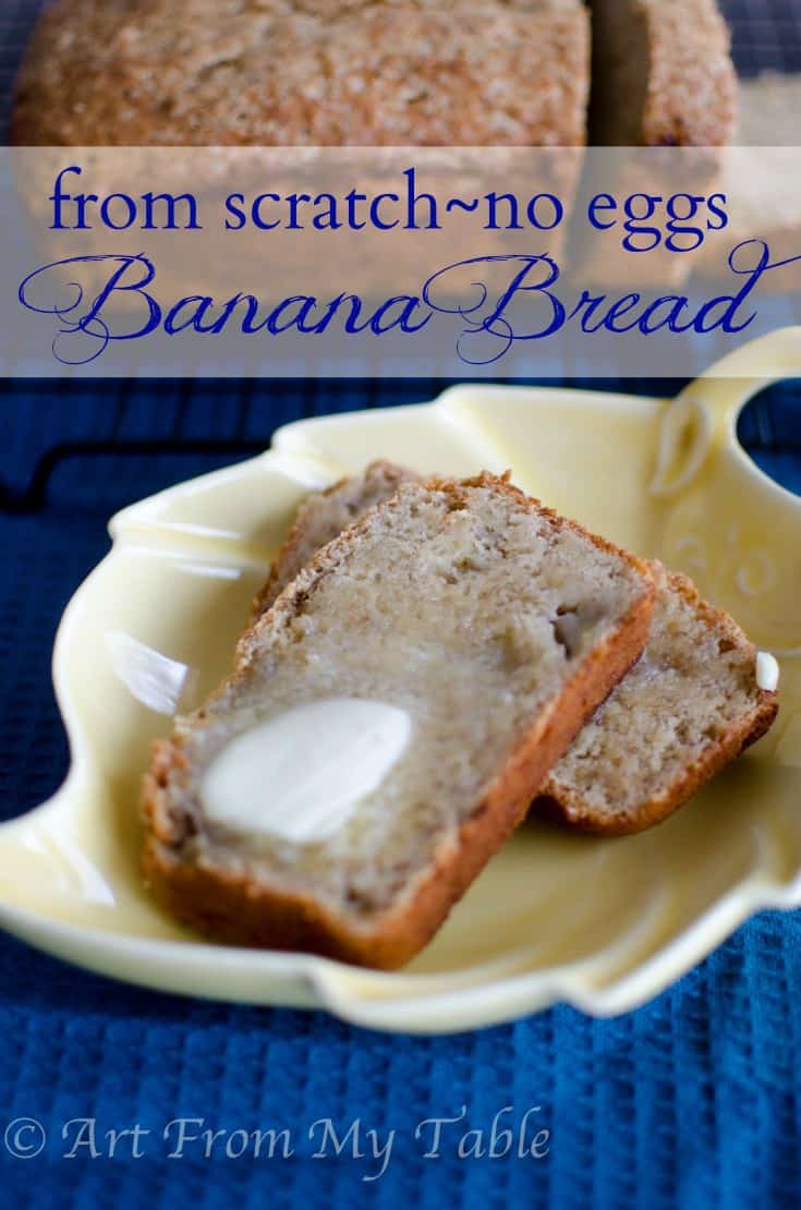 Two slices of banana bread on a plate with a pat of butter on top.