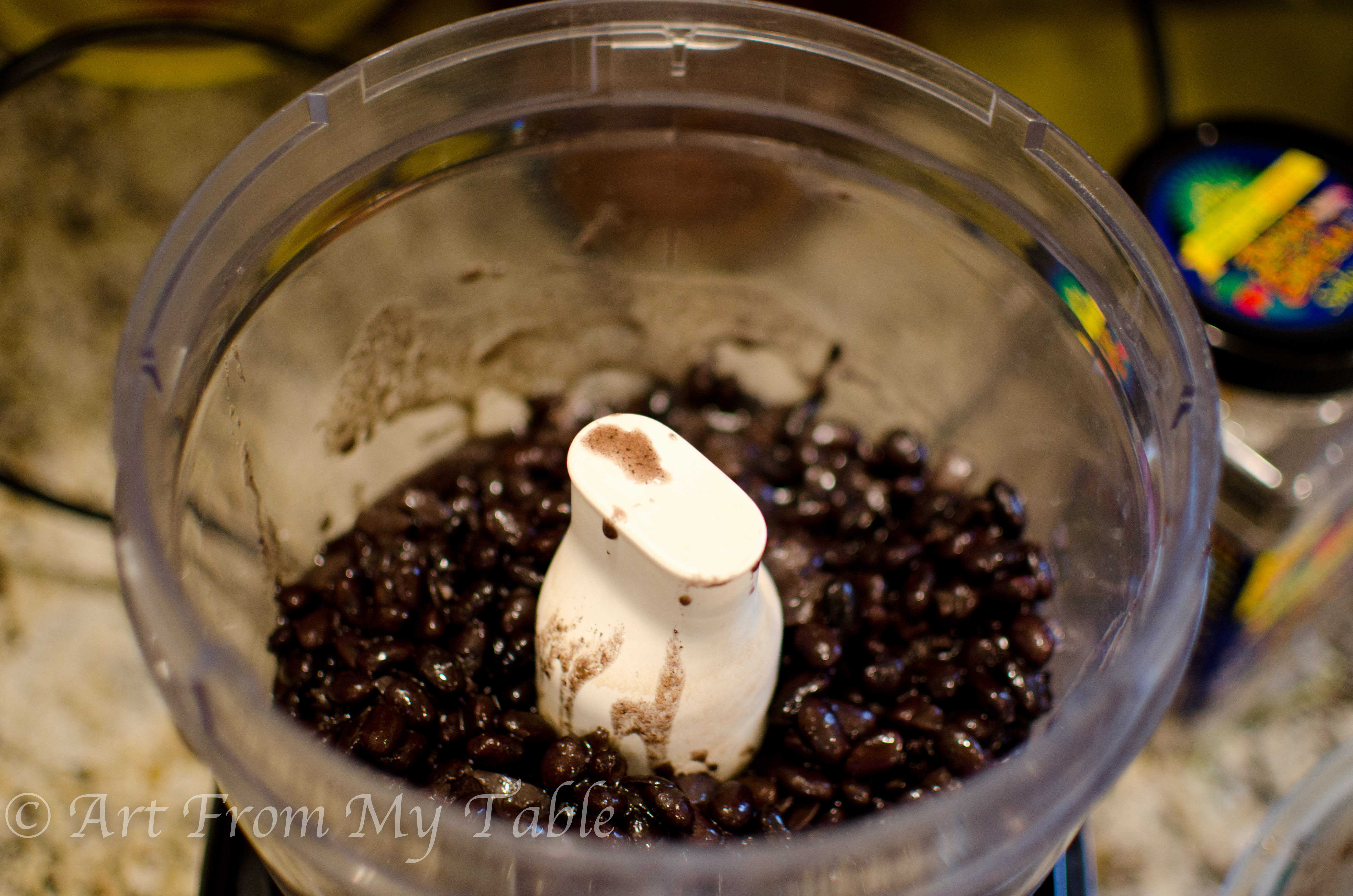 Cooked black beans in a food processor. 