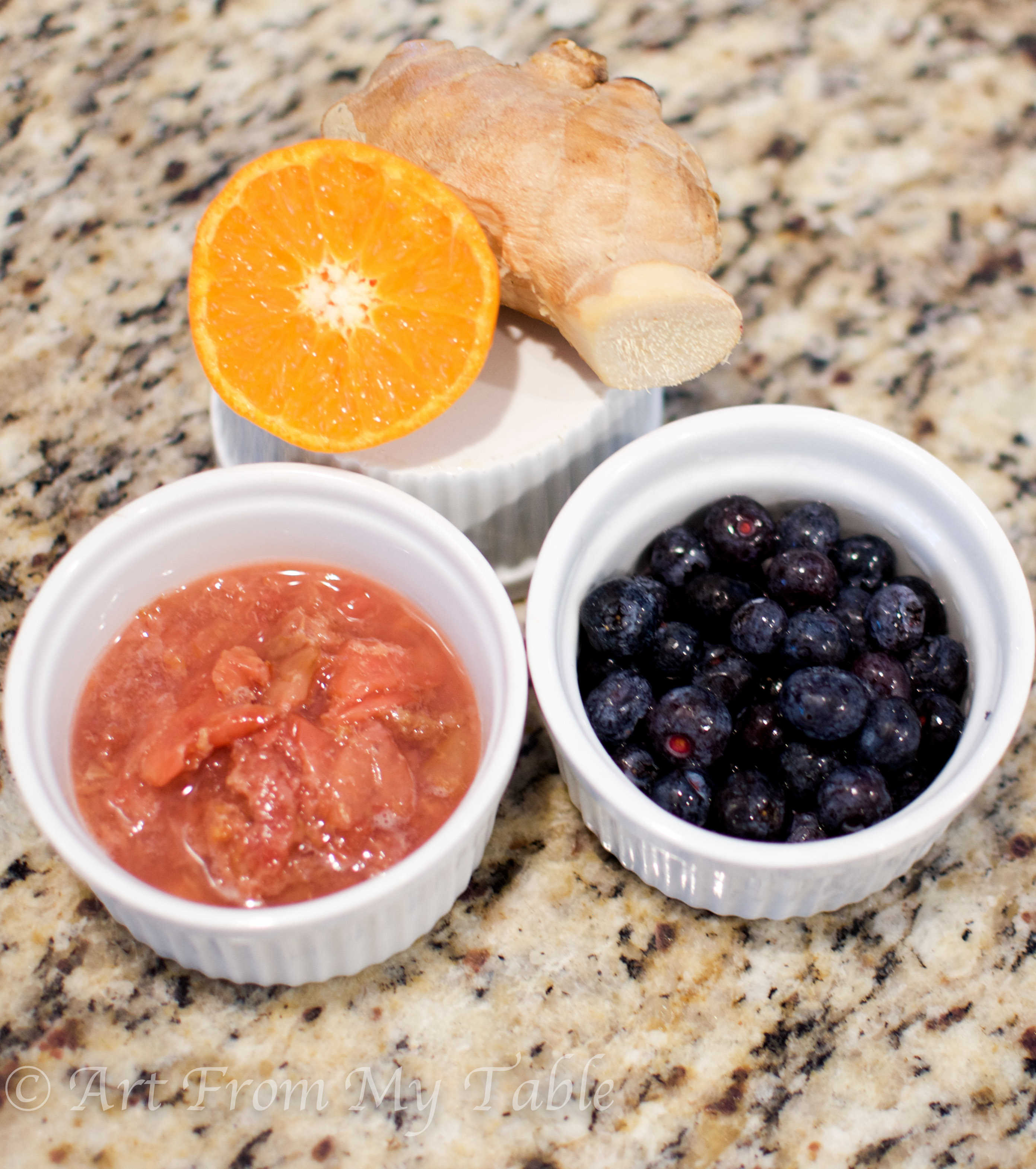 Flavorings for kombucha tea: thawed frozen cherries, thawed frozen blueberries, orange slice and fresh ginger. 