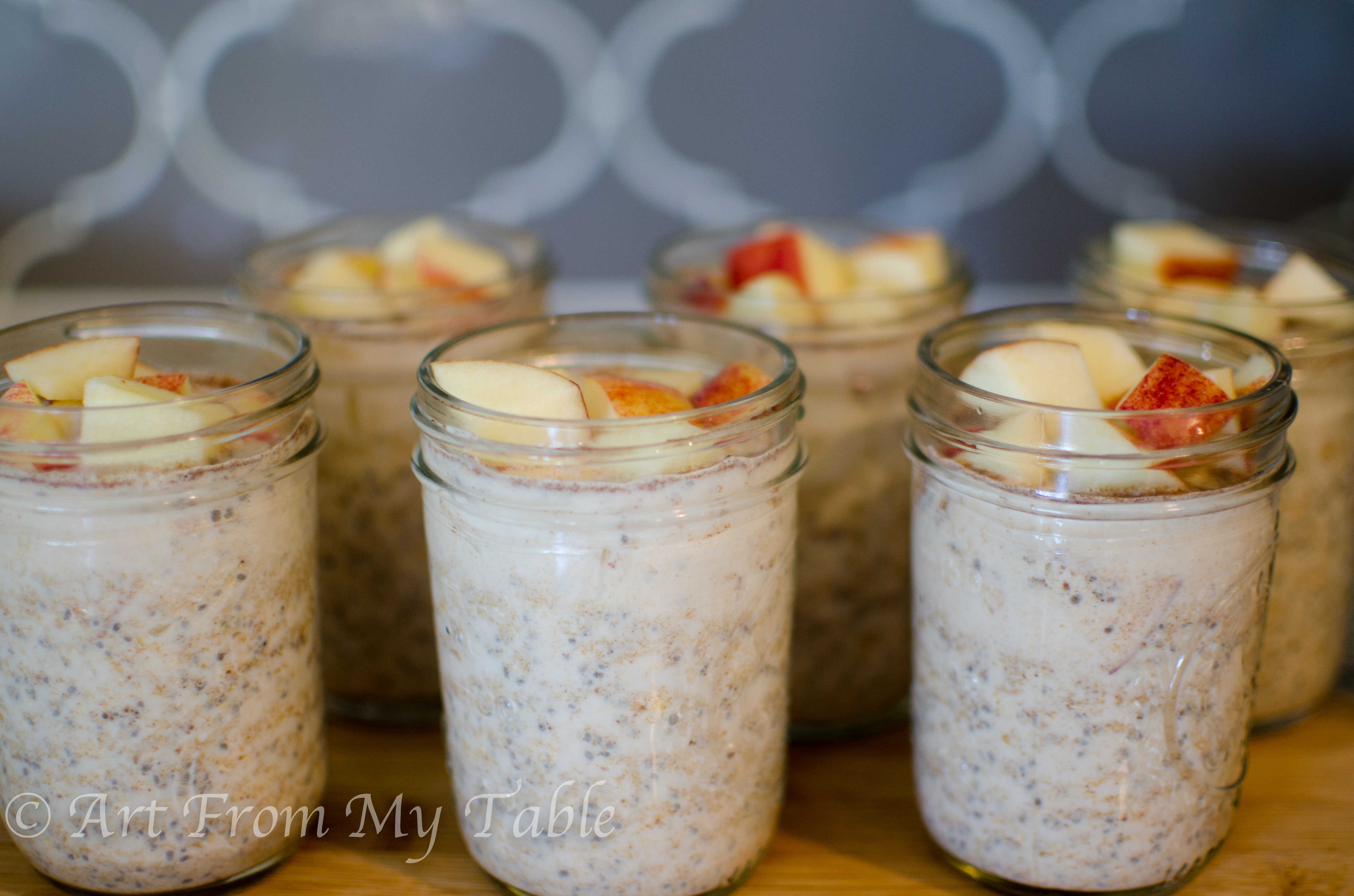 Mason jars with overnight oats topped with diced apples. 