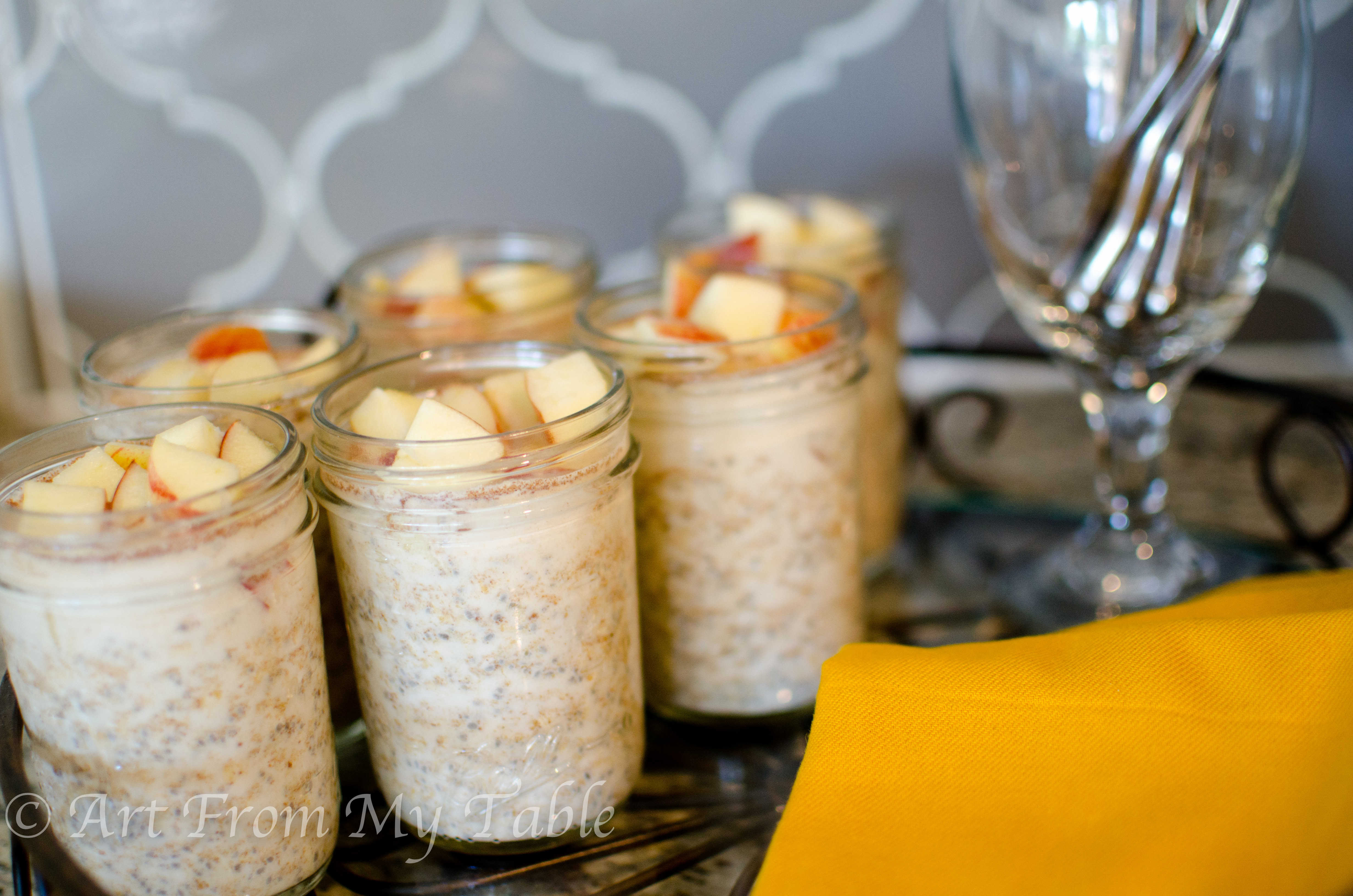 Apples and peanut butter flavored overnight oats on a serving tray. 
