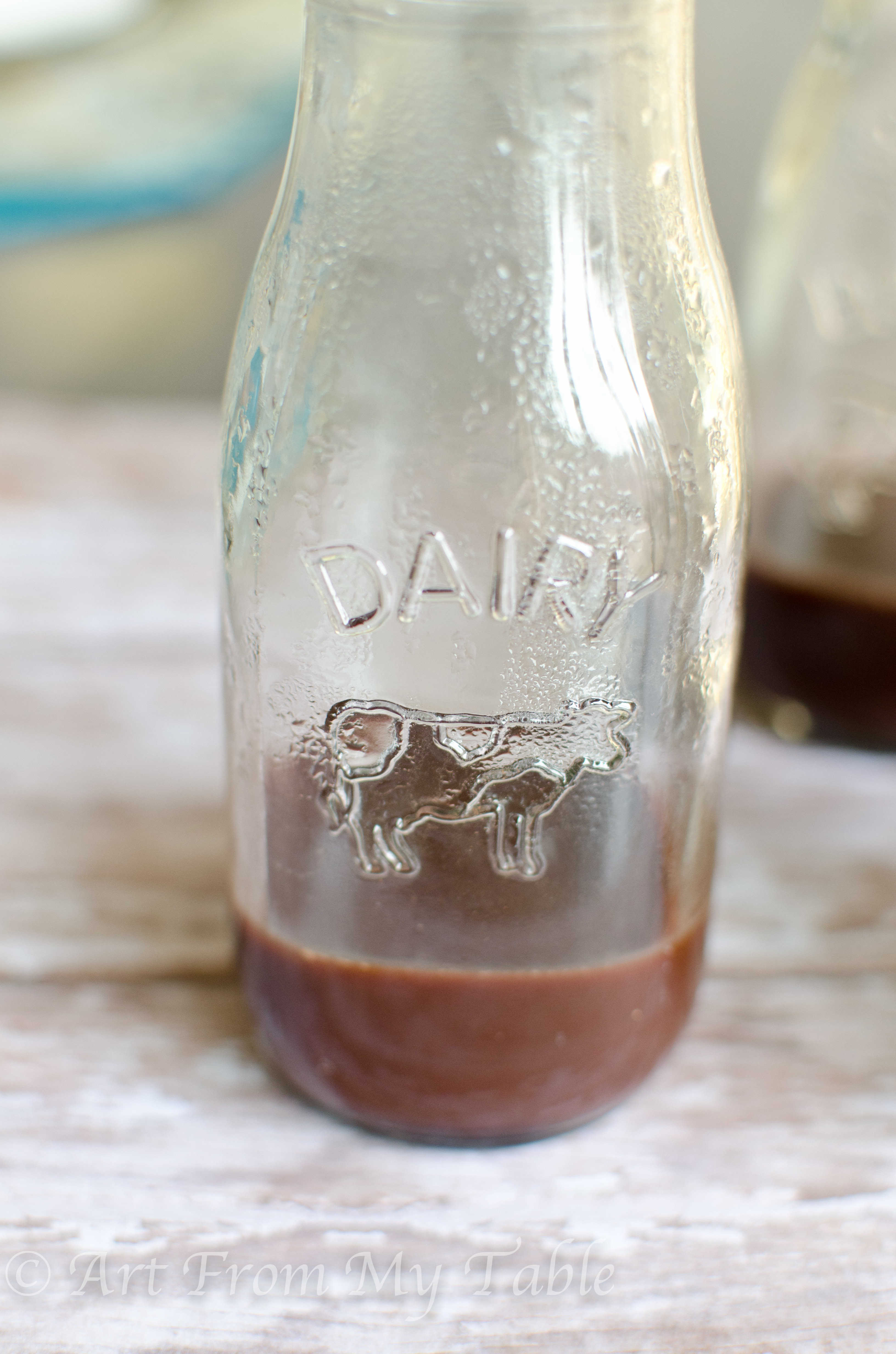 Step two of how to make chocolate milk, add a small amount of hot water.