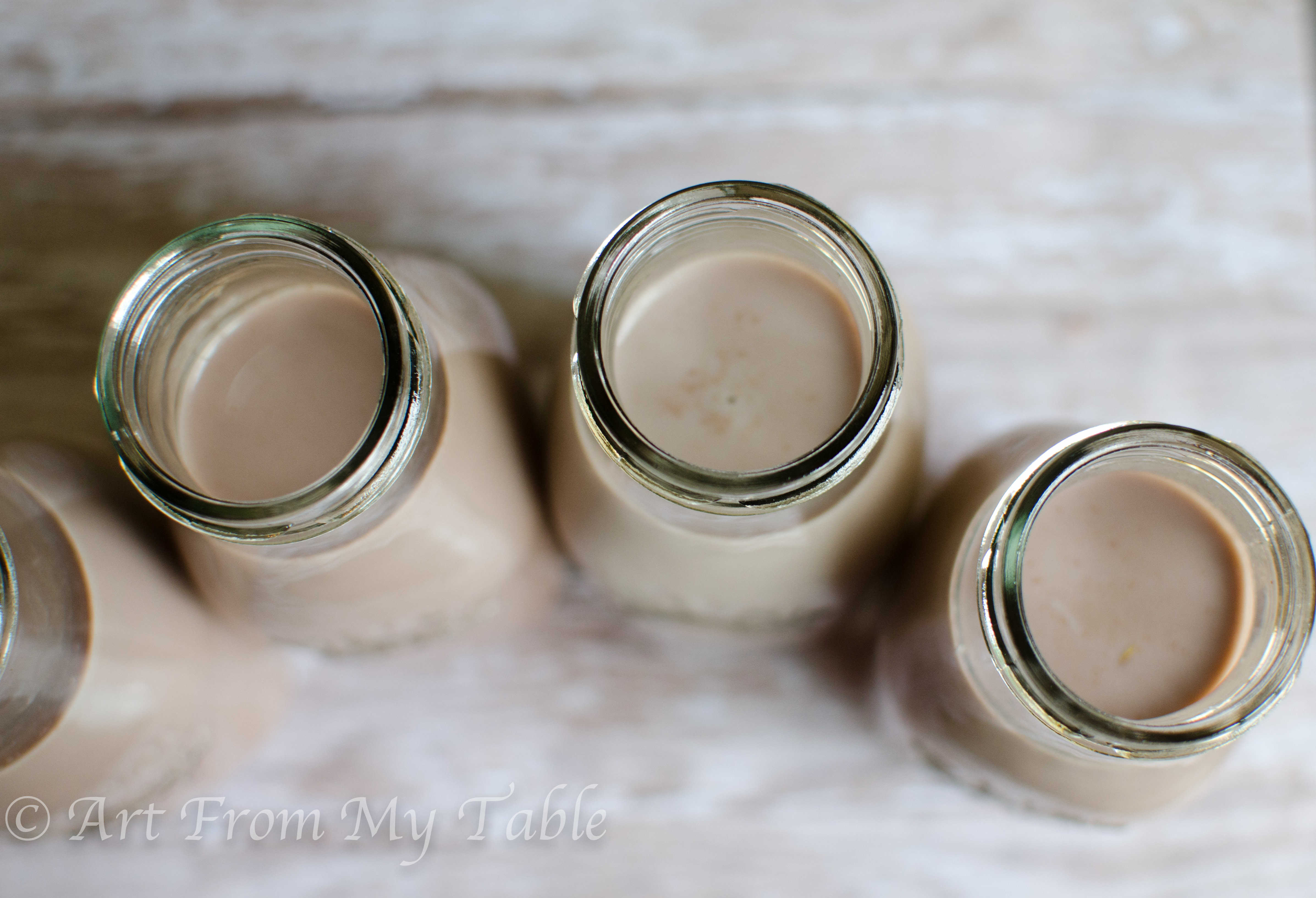 Glasses of homemade chocolate milk after the milk has been poured in (step 3).