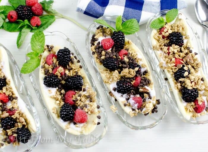 Four banana splits in dishes made healthier with yogurt, berries, granola and chocolate chips.
