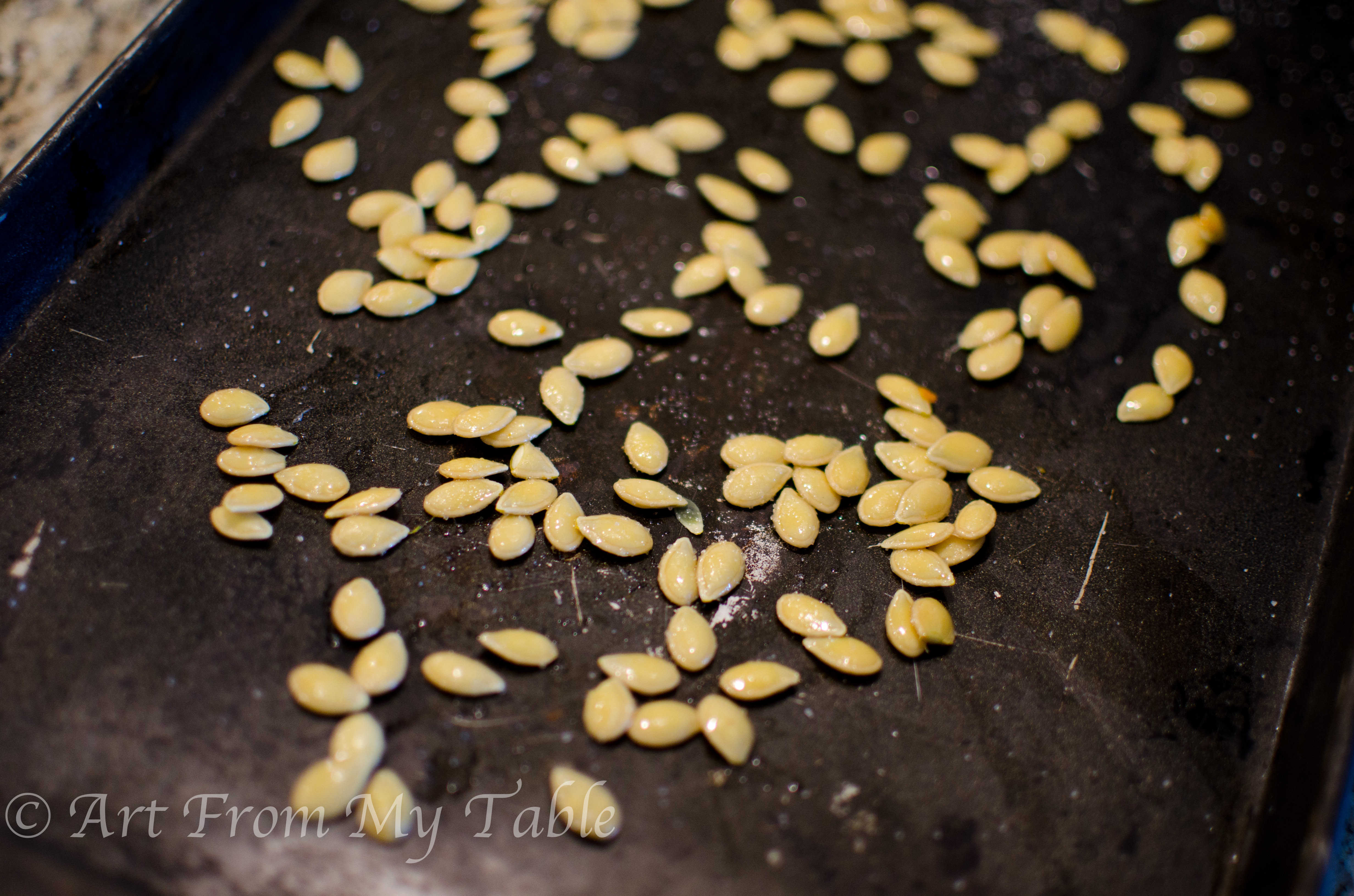 squash seeds on a baking sheet. 