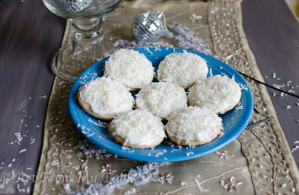 Coconut sugar cookies decorated with white frosting and shredded coconut. 