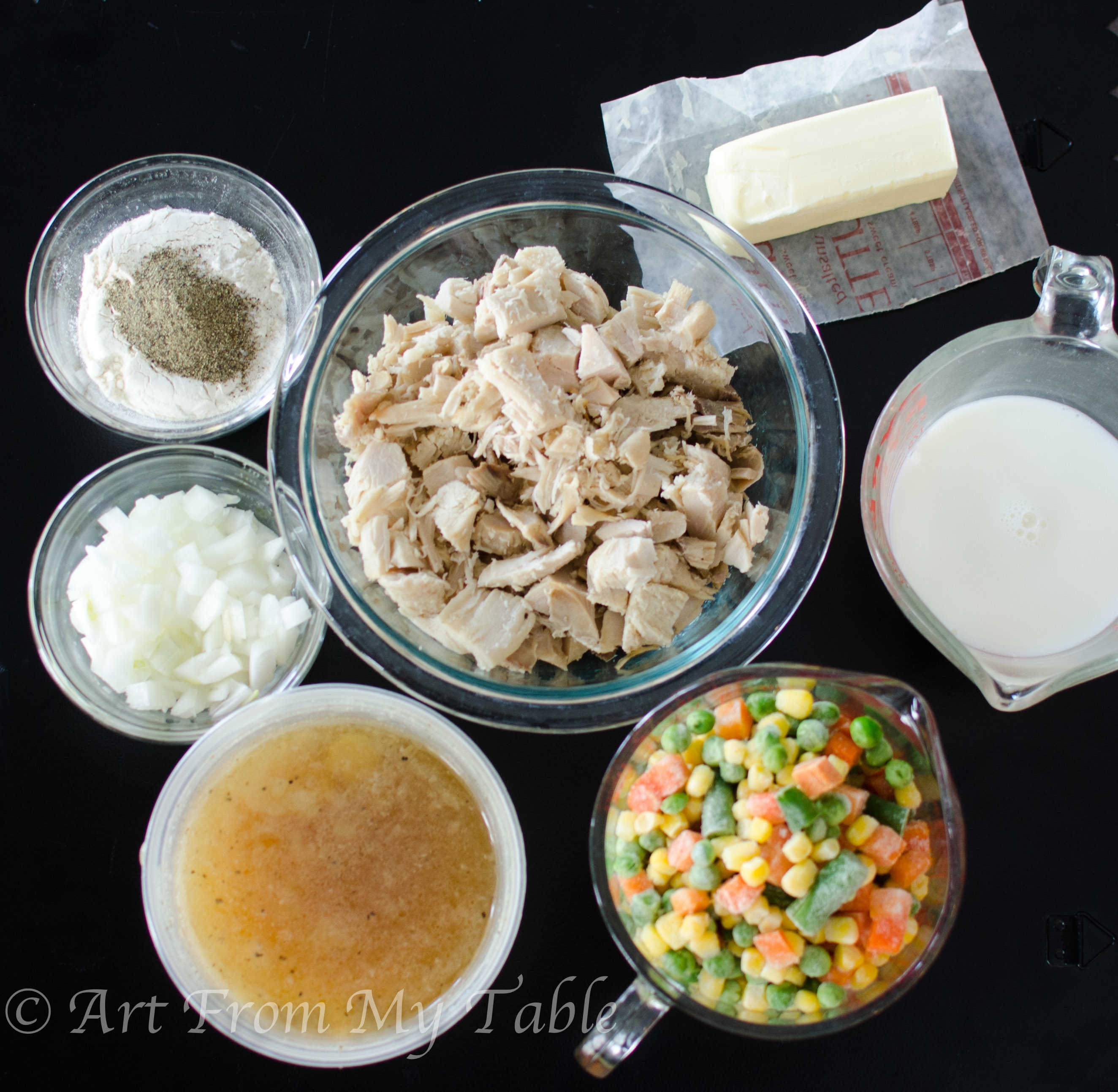 Ingredients for turkey pot pie - turkey, butter, milk, frozen vegetables, broth, onion, salt, pepper and flour.
