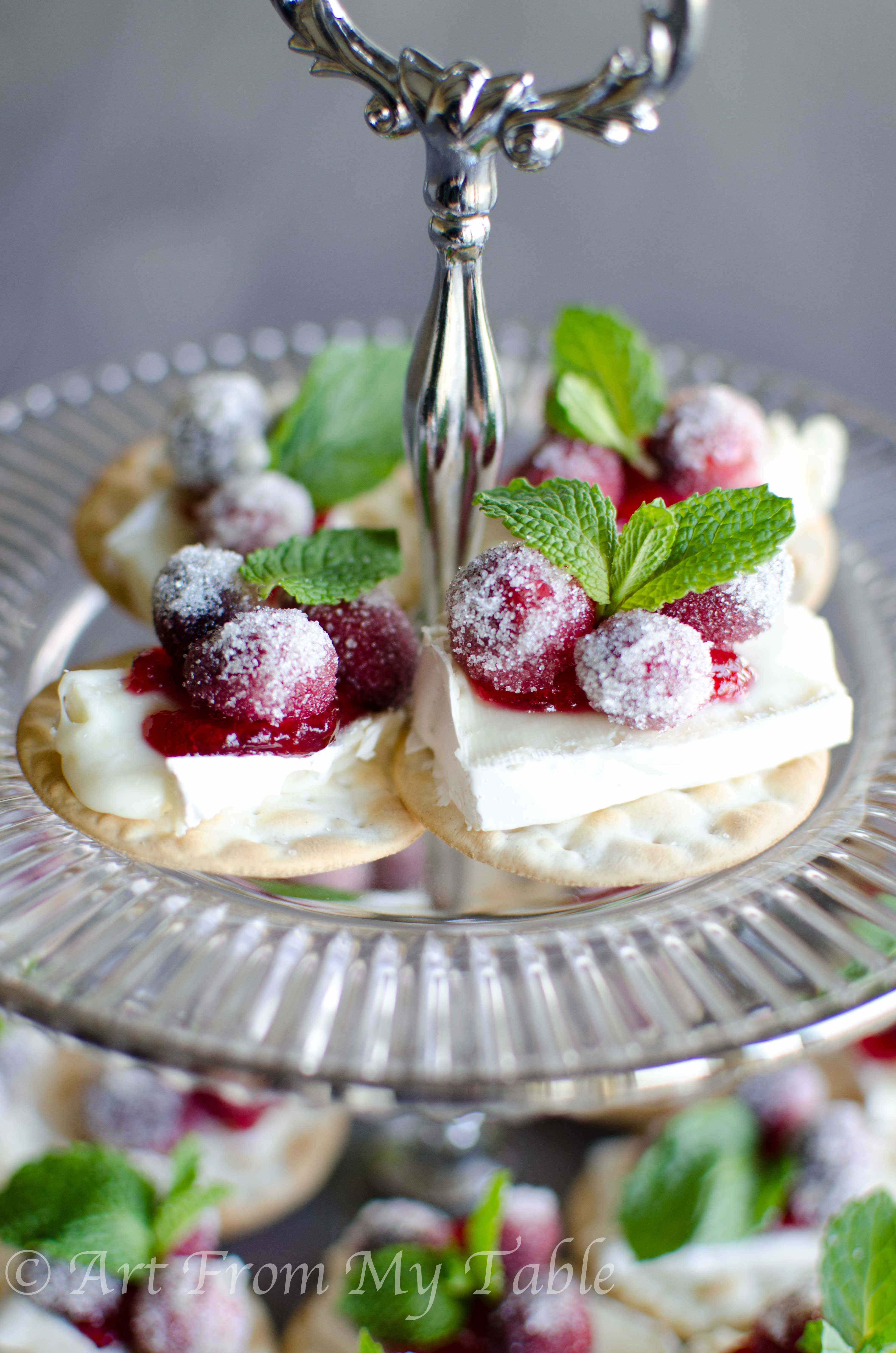 Cranberry brie bites on a tiered tray.
