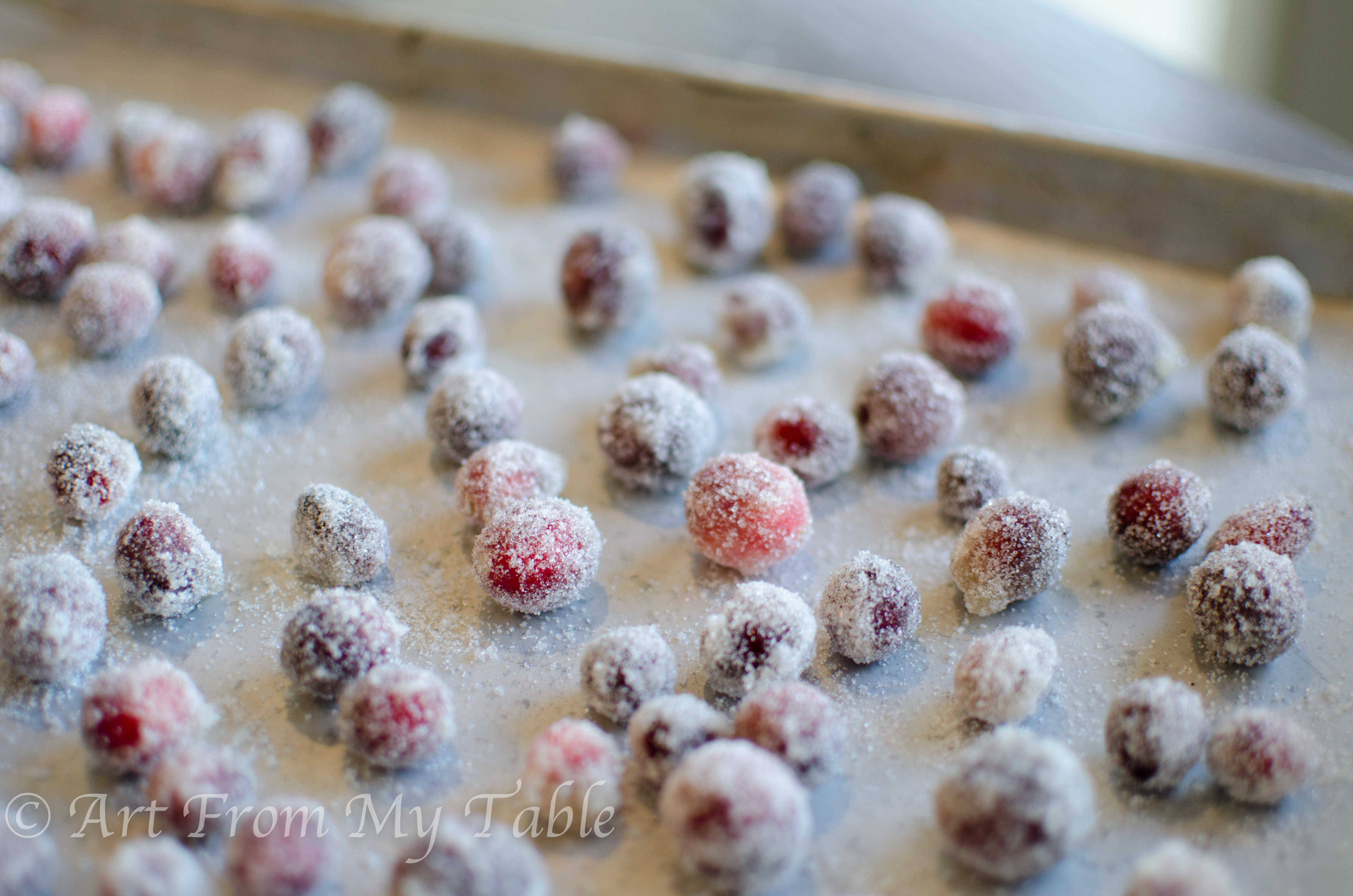 Sugared cranberries on a baking sheet.