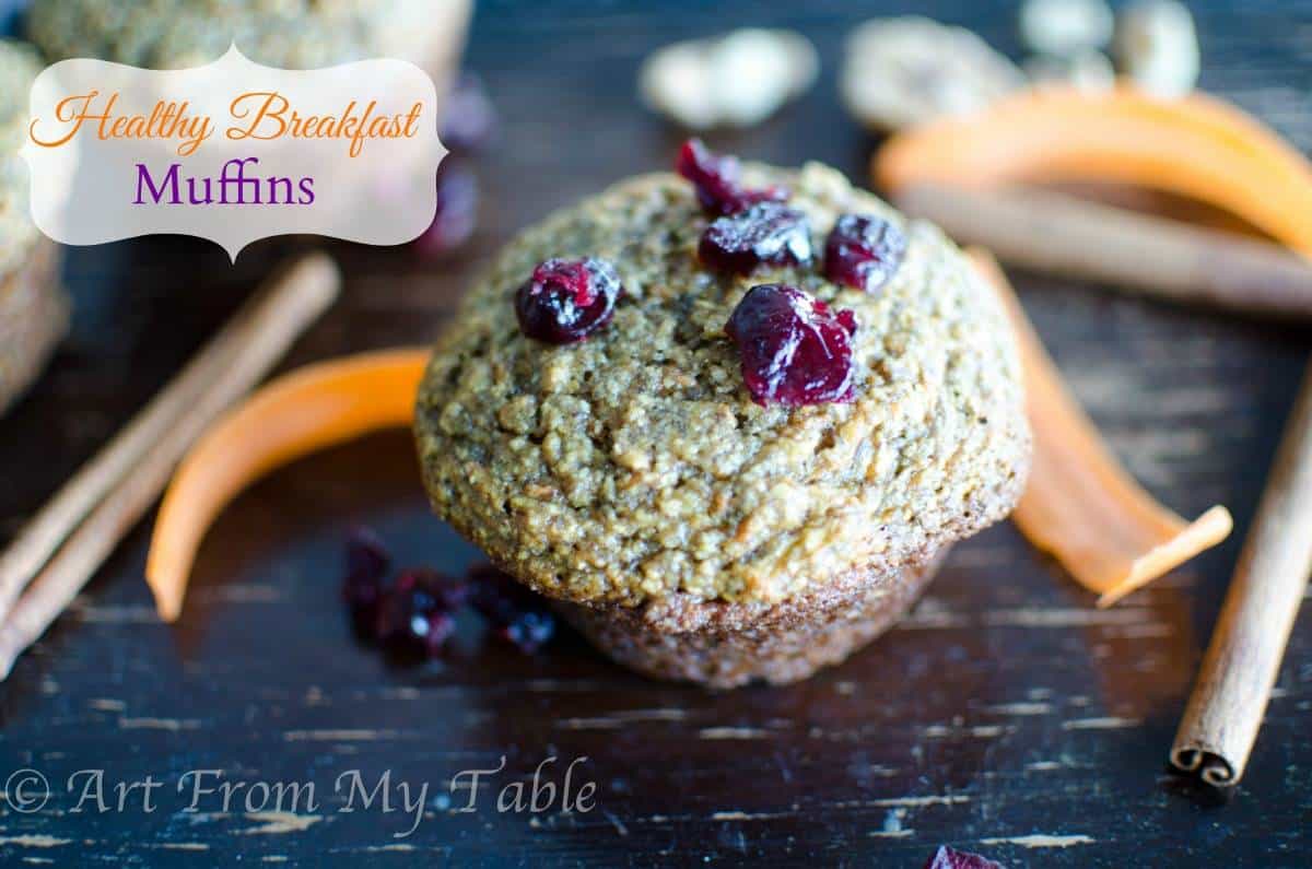 Bran muffin on a tray with some dried cranberries on top.