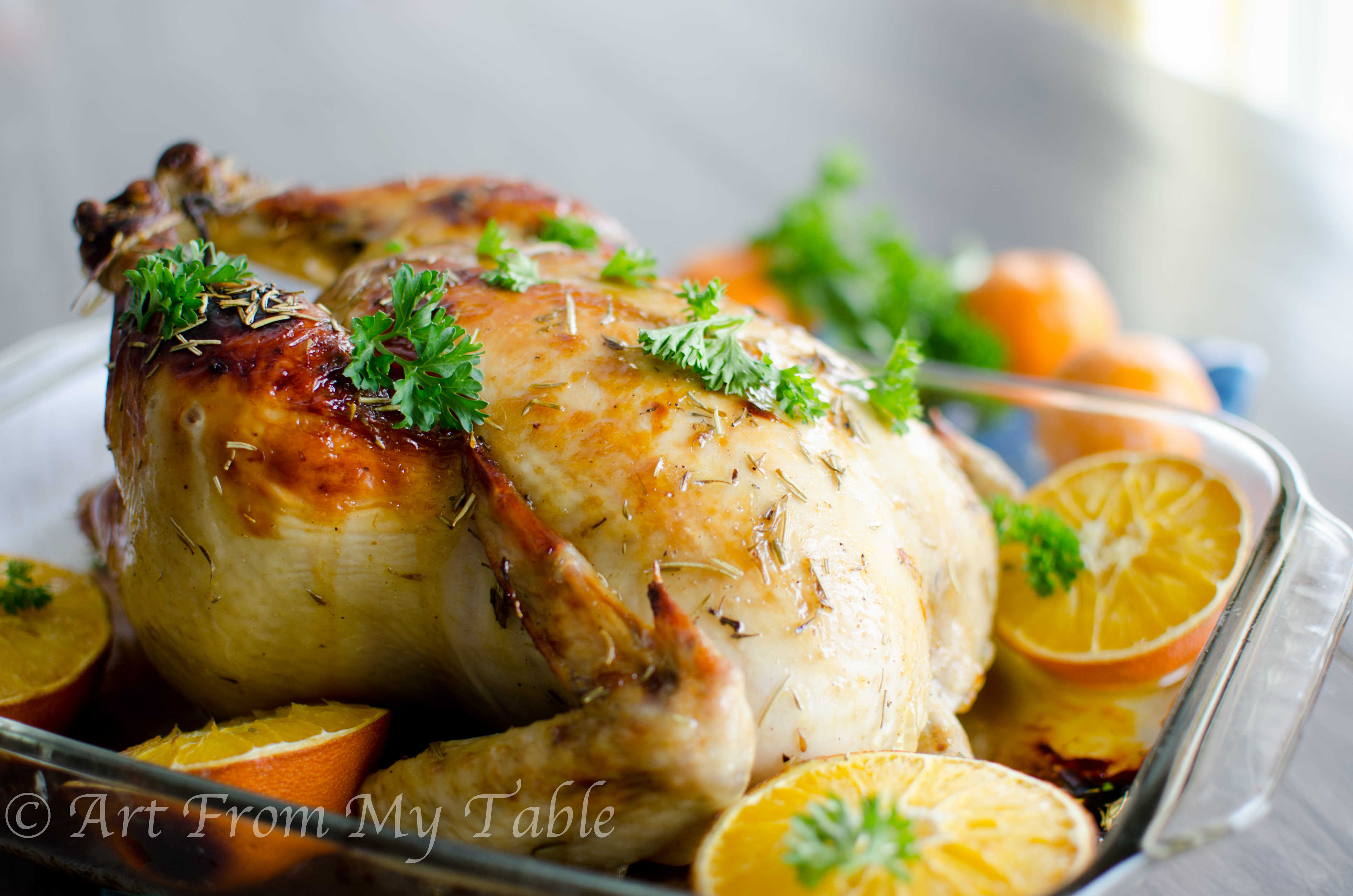 Easy roasted chicken with orange glaze garnished with fresh parsley.