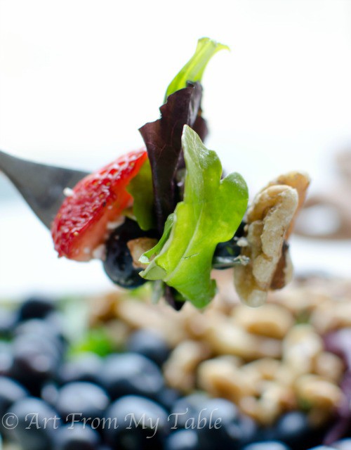 Forkful of red, white, and blue salad.