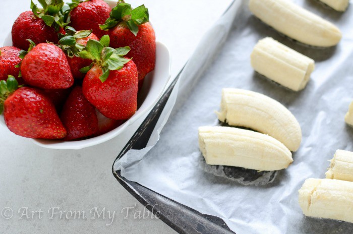 Ingredients for dairy free "nice cream", fresh strawberries and frozen bananas.