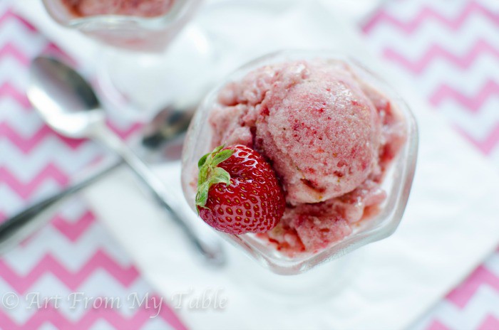No-churn dairy-free strawberry banana ice cream in a dish with a fresh strawberry.