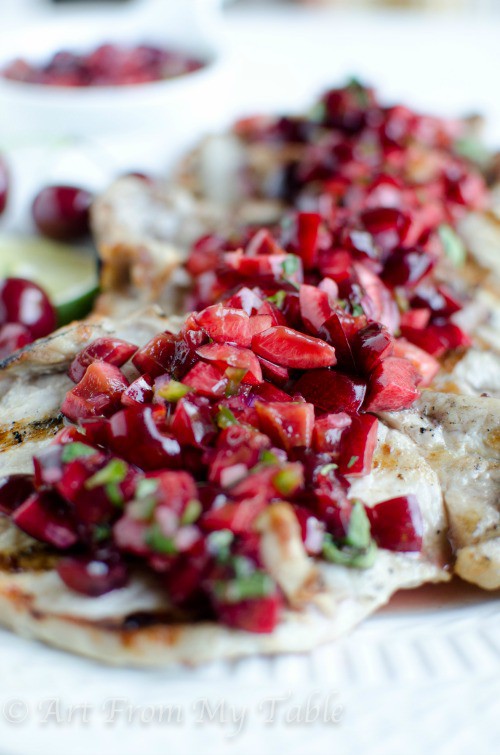 Grilled pork topped with tangy zesty cherry salsa