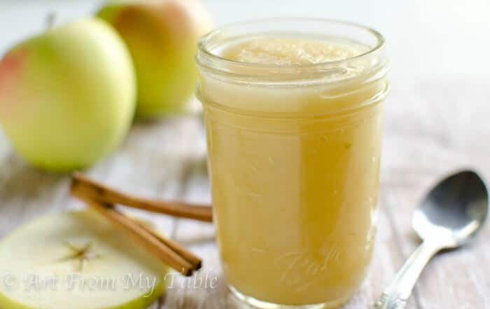 No added sugar Applesauce in a mason jar with a spoon.