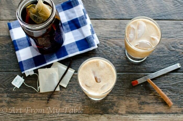 Mason jar full of Tea concentrate next to two glasses of metabolism boosting creamy iced tea.