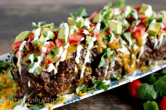 Low carb Mexican meatloaf after cooking garnished with all the fresh toppings. 
