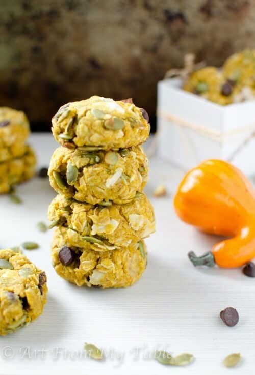 Pumpkin breakfast cookies stacked with other cookies nearby.