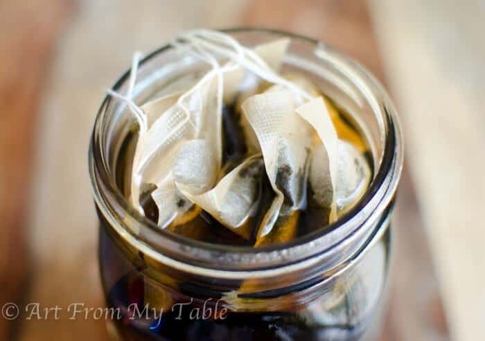 Mason jar filled with water and 8 tea bags, brewing.