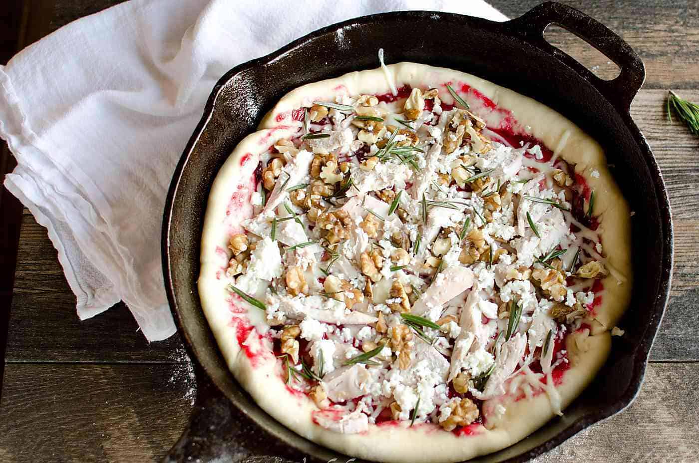 Turkey Cranberry Pizza in a cast iron pan.