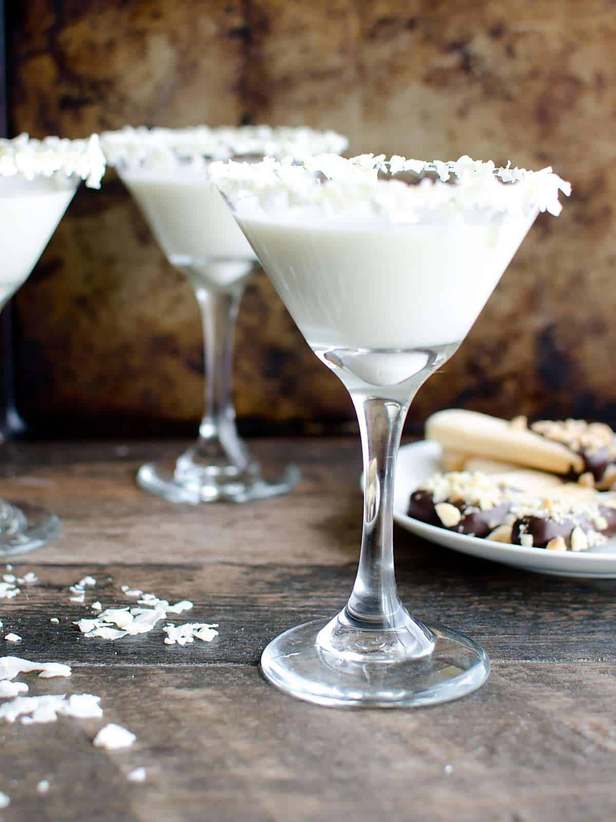 Nonalcoholic pineapple coconut martini's with a plate of chocolate dipped lady fingers. 
