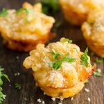 lobster mac and cheese bites sitting on a platter garnished with fresh parsley