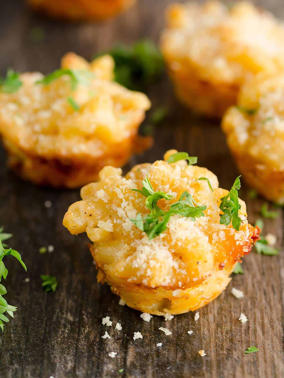 baked lobster mac and cheese "bites" garnished with parsley. 