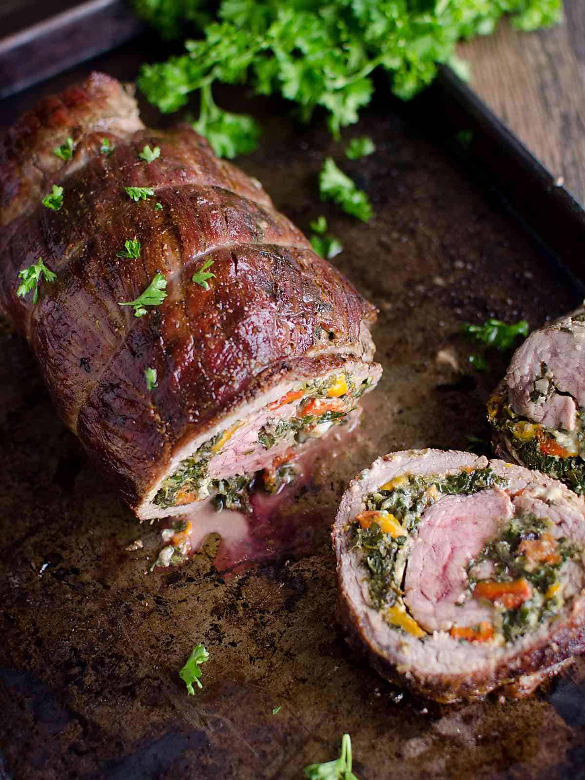Flank steak roll stuffed with spinach peppers and blue cheese, sliced like pinwheels