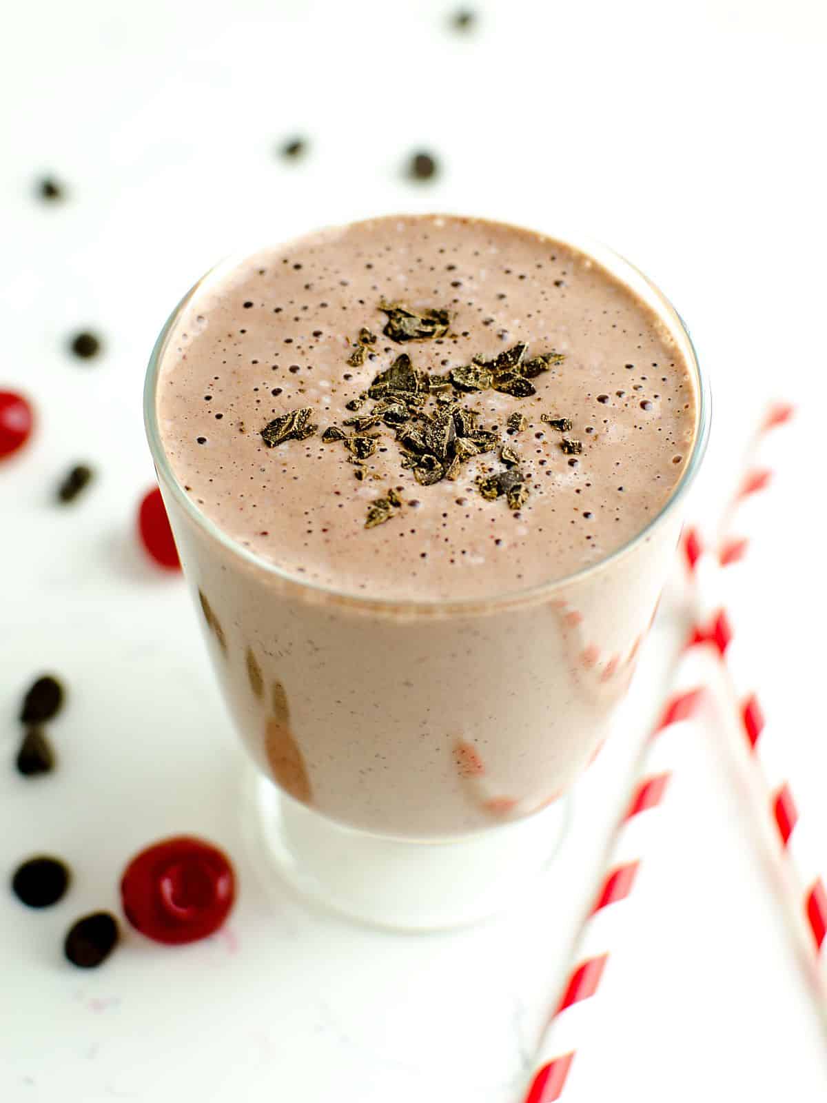 Chocolate covered cherry protein smoothie topped with dark chocolate shavings.