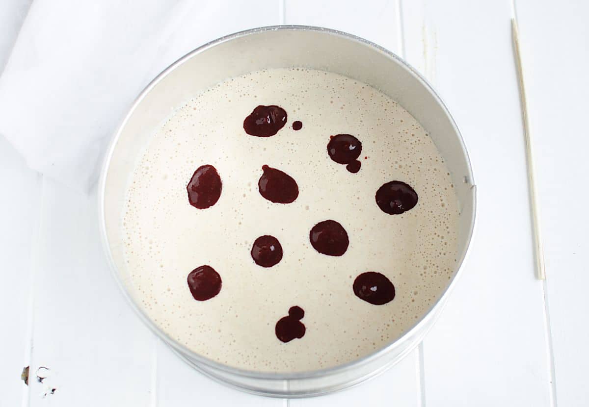 breakfast cake batter dotted with pureed cherries dotted on top.