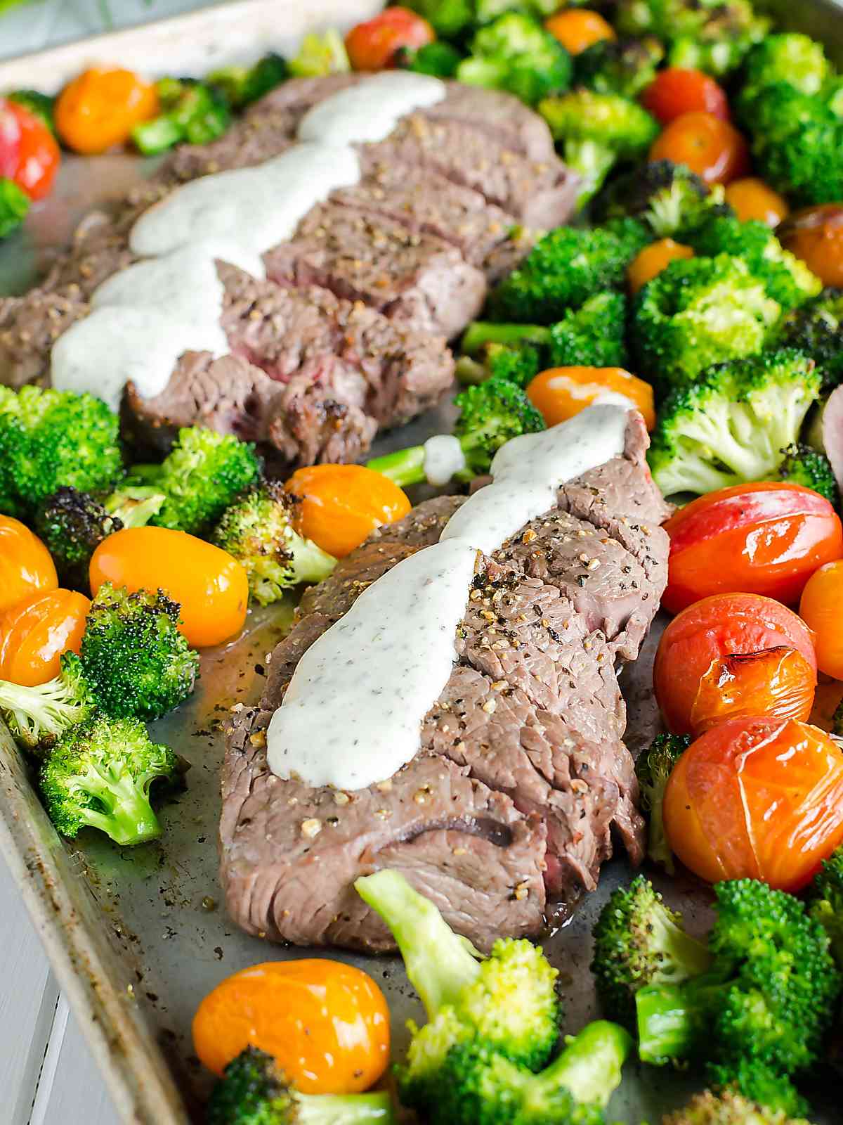 Sheet Pan Steak and Veggies drizzled with Boursin Cheese Sauce, all on one pan.