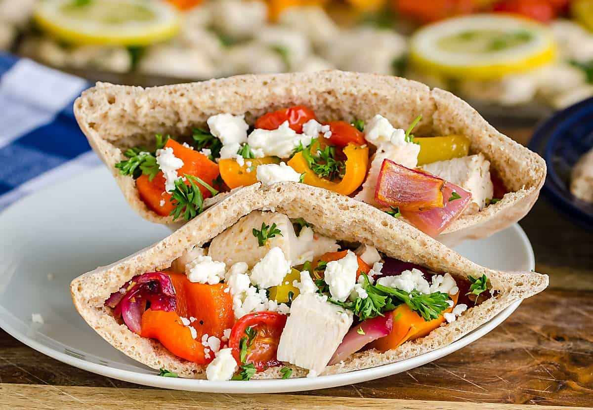 Greek chicken, diced peppers, onions, tomatoes stuffed into a whole wheat pita topped with feta cheese and parsley.