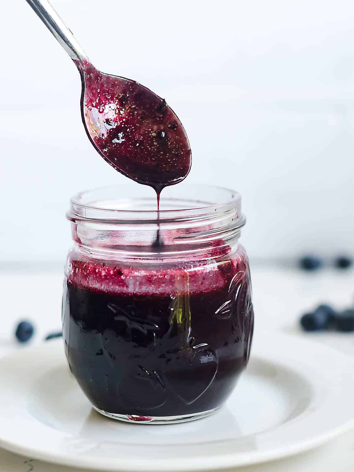 blueberry balsamic vinaigrette dripping off a spoon.