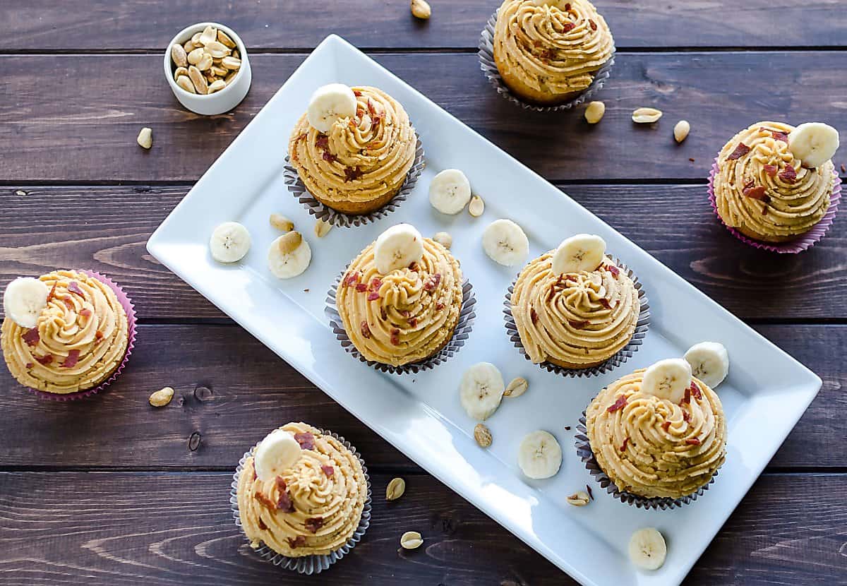 elvis peanut butter cupcakes garnished with bacon crumbles and banana slices.