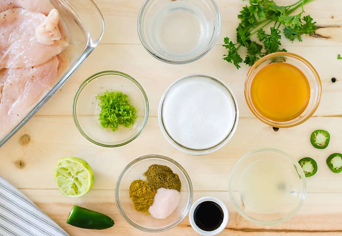 ingredients for coconut lime chicken marinade: lime zest, coconut milk, honey, spices, lime juice, jalapeno.