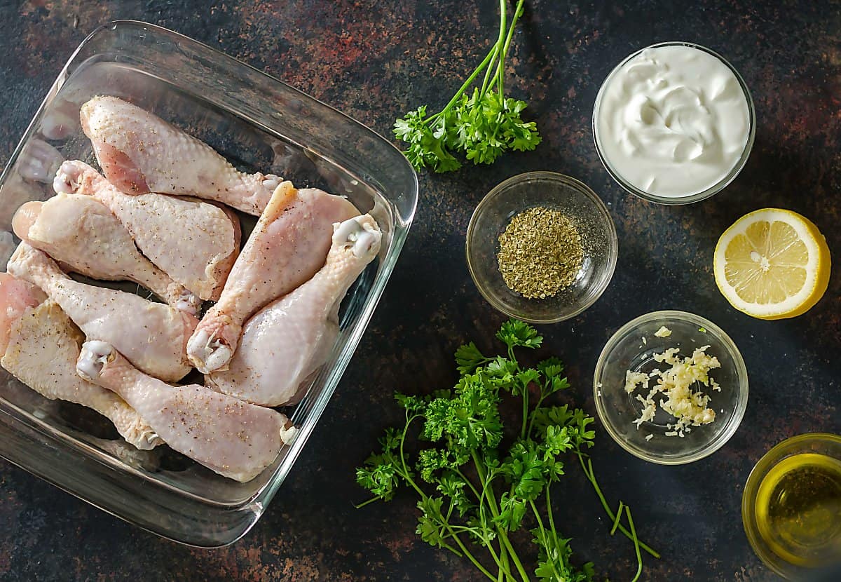 ingredents for yogurt marinated chicken legs, chicken, yogurt, lemon, garlic, oregano.