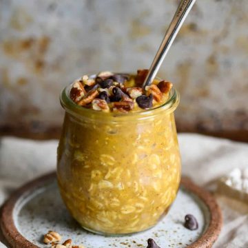 pumpkin overnight oats garnished with pecans and chocolate chips