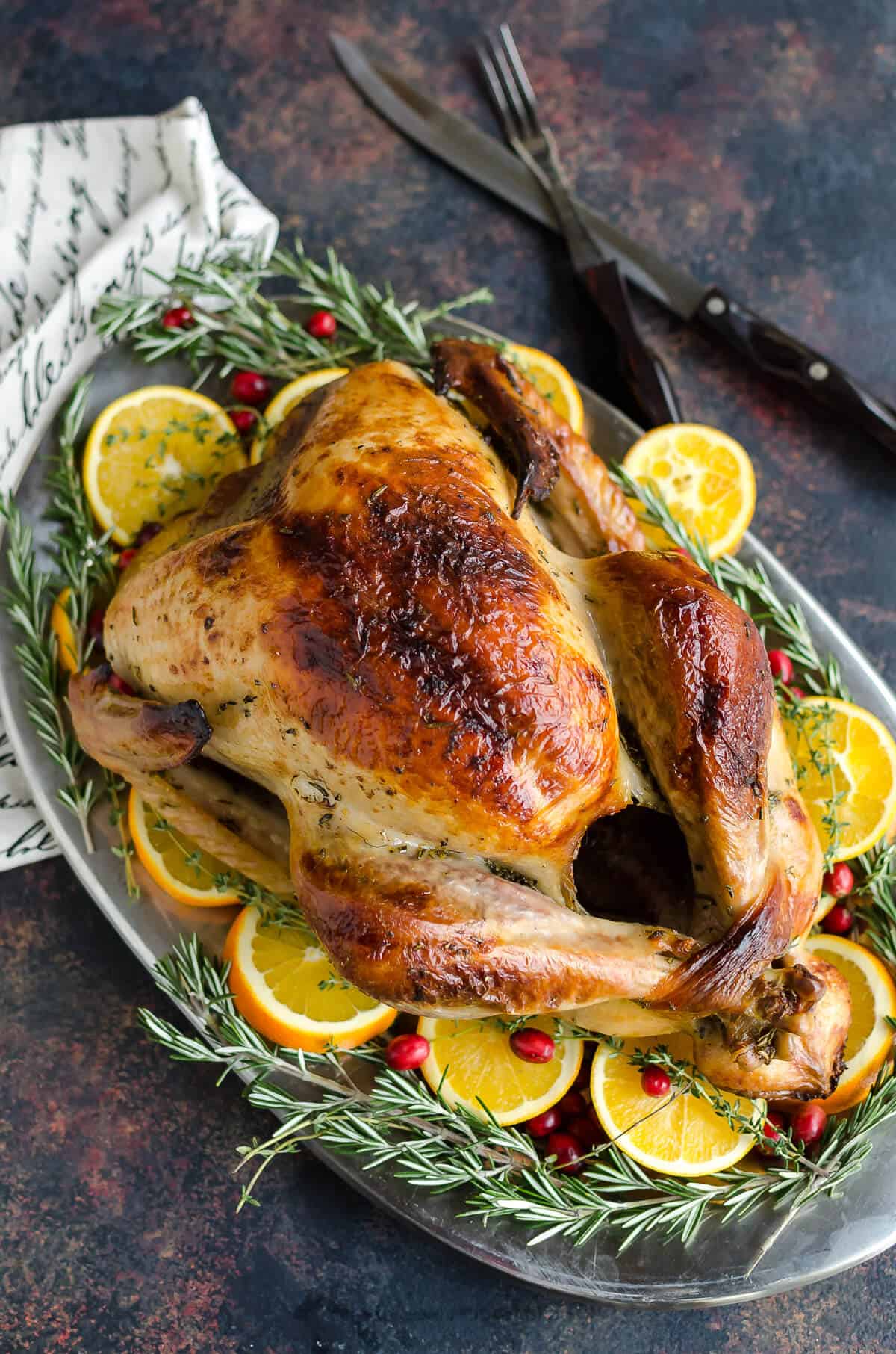 Golden roasted turkey with meat thermometer on table Stock Photo