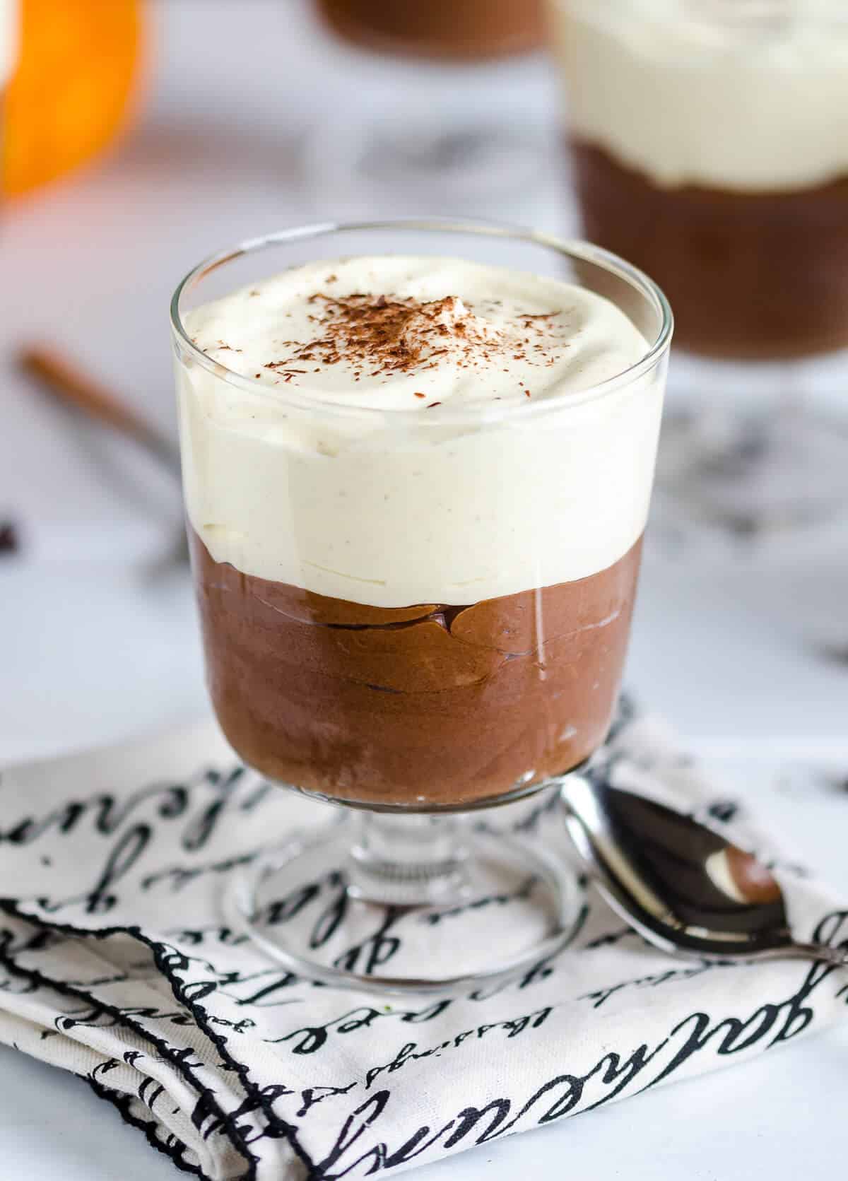 quick easy chocolate mousse with pumpkin whipped cream in a clear glass dish
