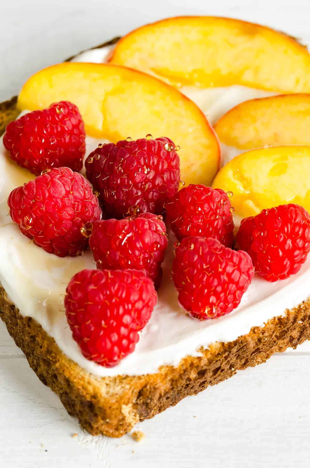 Raspberry Peach Breakfast Toast, whole grain bred, yogurt, honey, fresh raspberries, fresh peach slices