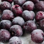 group of frozen sweet cherries with frost on them