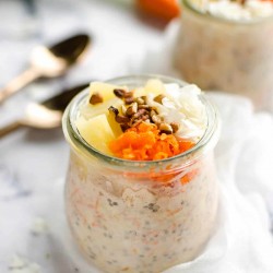 jar of carrot cake overnight oats topped with grated carrots, pineapple, coconut and pecans