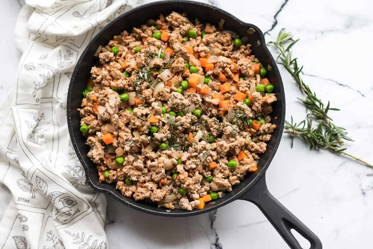 cottage pie filling in cast iron skillet.
