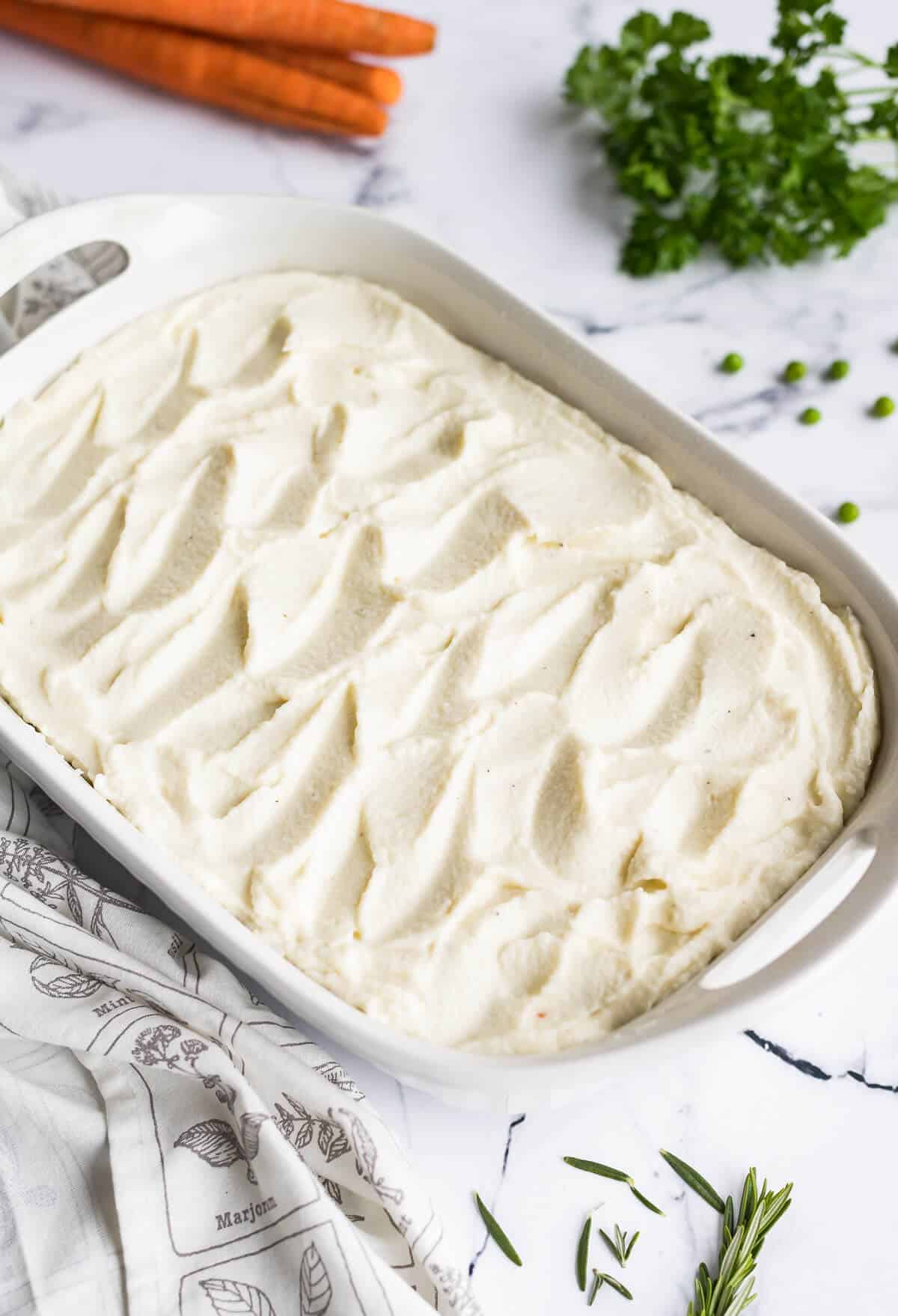 cottage pie with cauli flower mash in a 9x 13 dish before being baked.