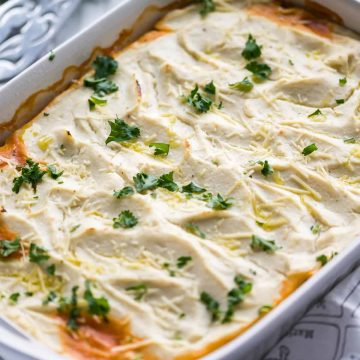 cottage pie with cauli mash in a white 9x13 dish garnished with parmesan cheese and parsley