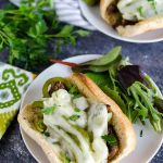 homemade philly cheesesteak on a bun with a side salad