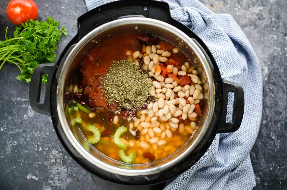 instant pot filled with pasta fagioli soup ingredients and spices, not cooked yet