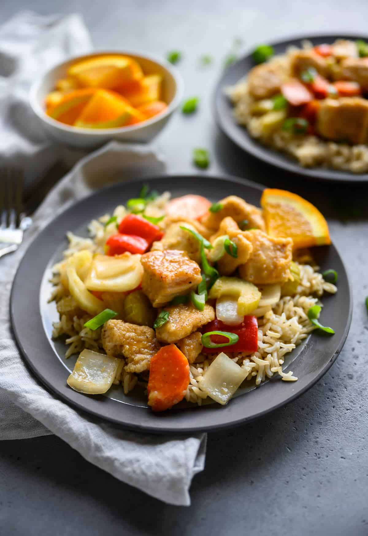 Crockpot orange chicken over rice on a plate