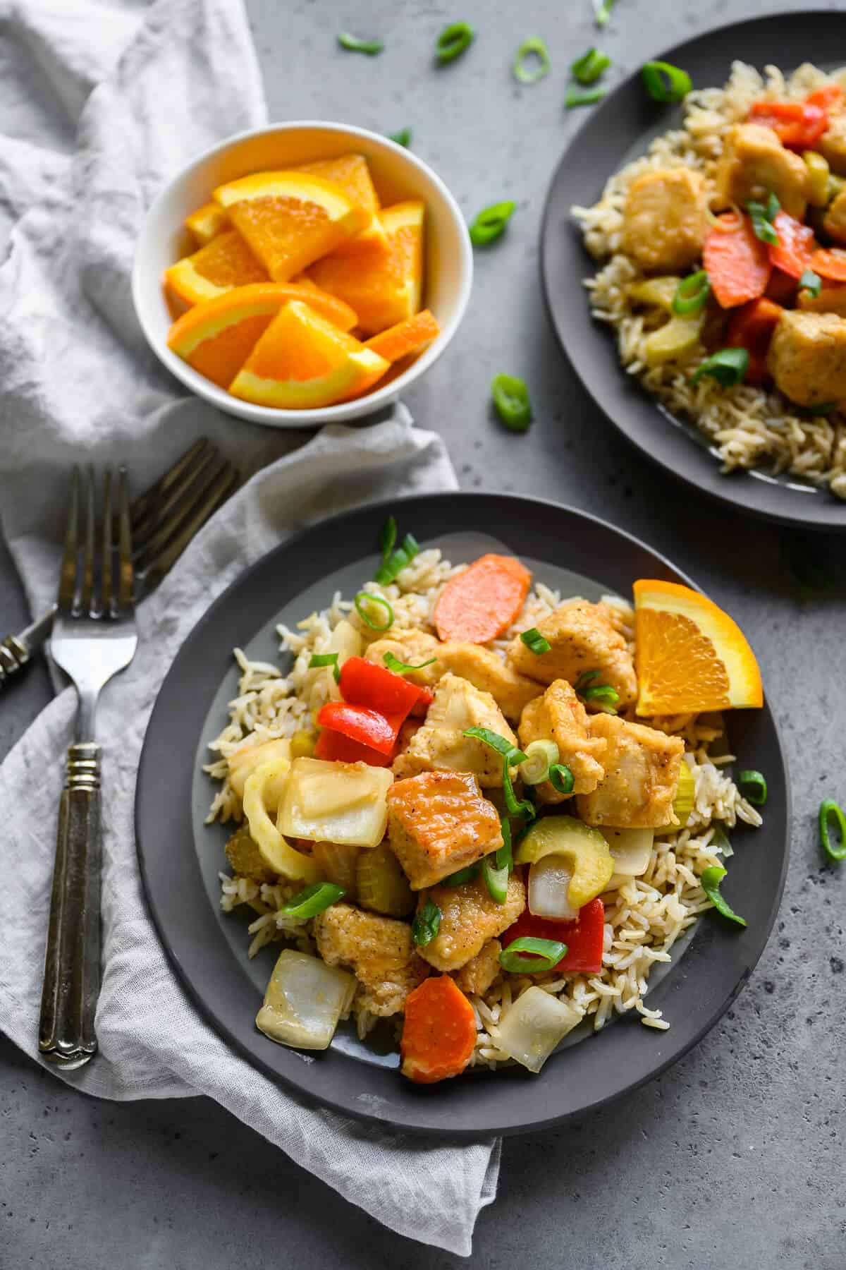 slow cooker orange chicken served over rice on a plate